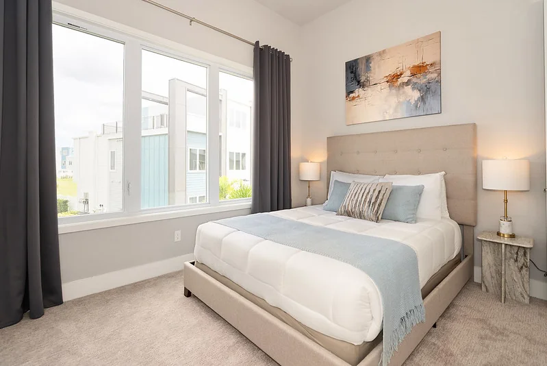 Primary suite bedding layered for professional STR photography