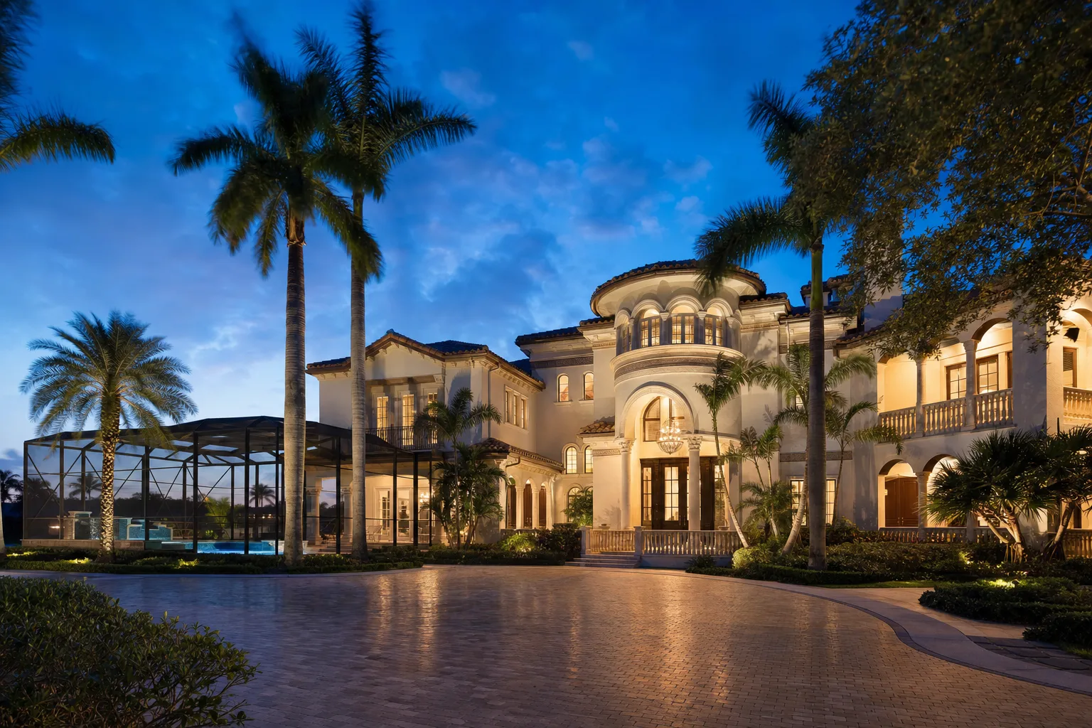 Mega-Rental Specialty great room at dusk — U-shape custom velvet sectional, 120" wall TV in stone feature wall.